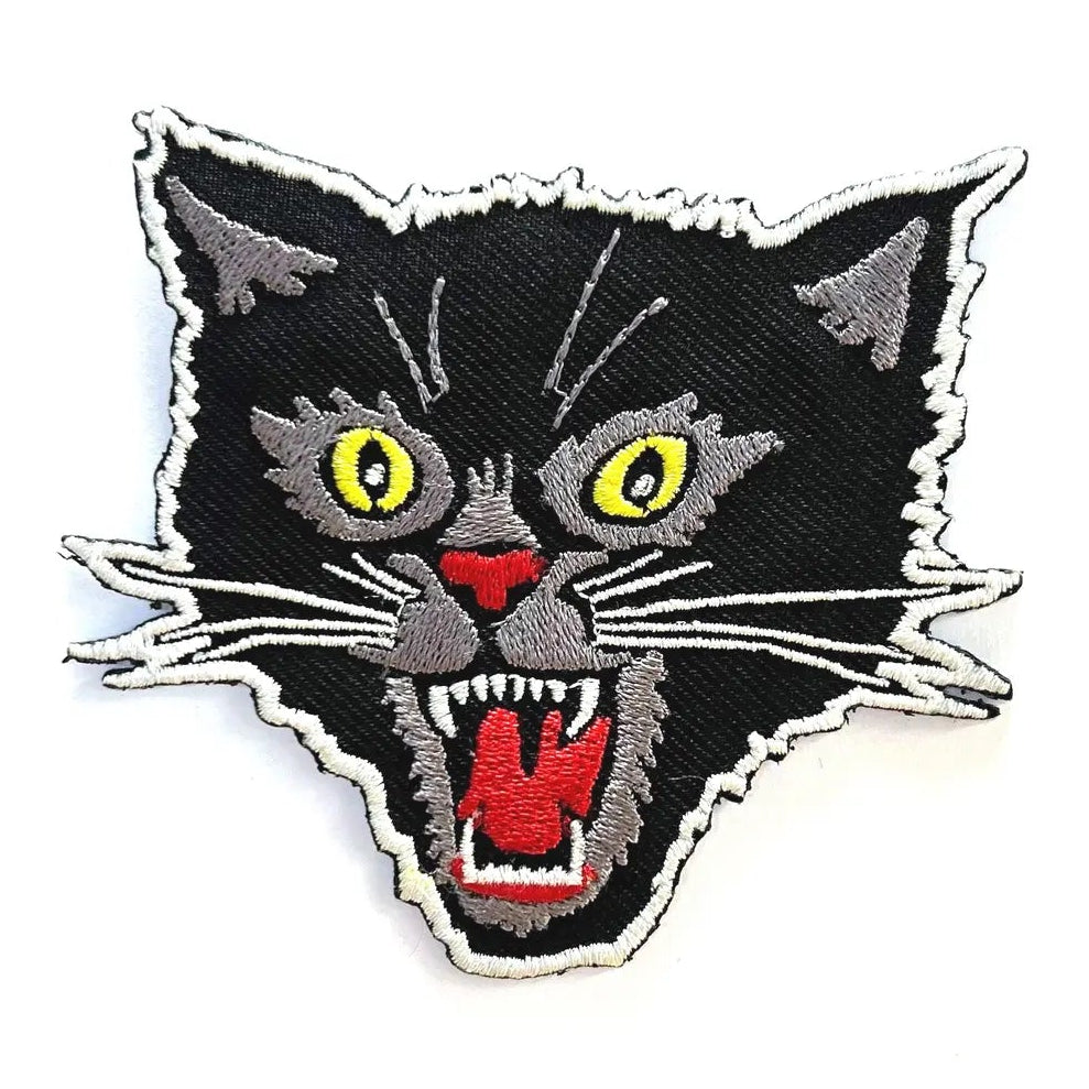 Embroidered patch of a black cat with yellow eyes and red mouth on a white background