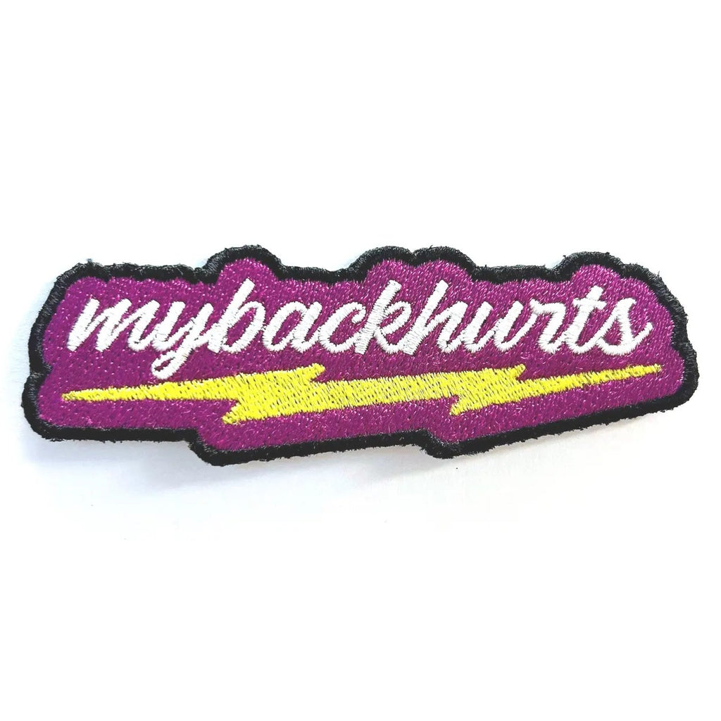Hot pink patch with white 'mybackhurts' script above a yellow lightning bolt